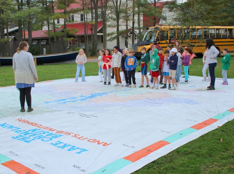 Group of students standing on the Giant Map.